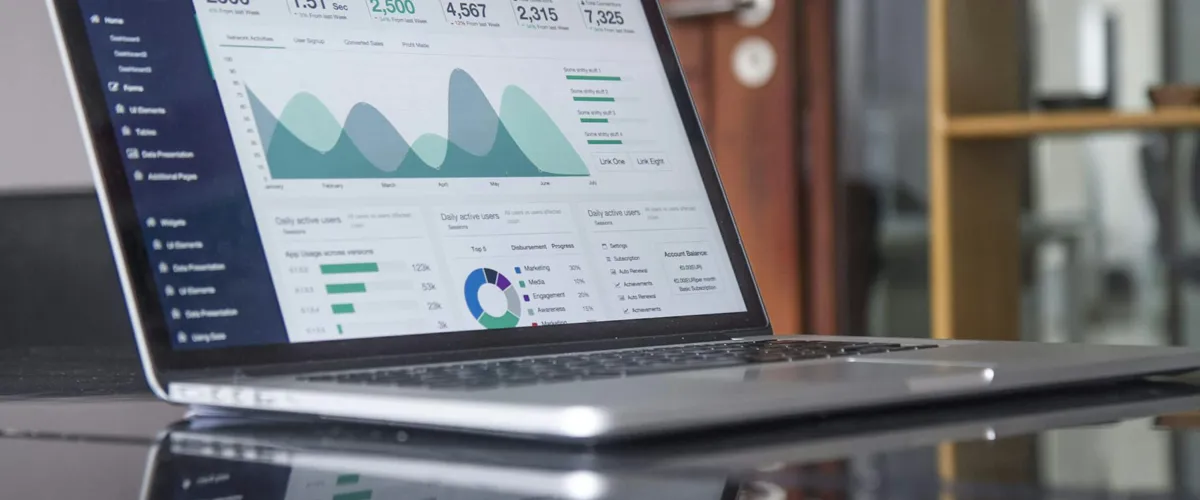 Business charts and graphs on paper and screen