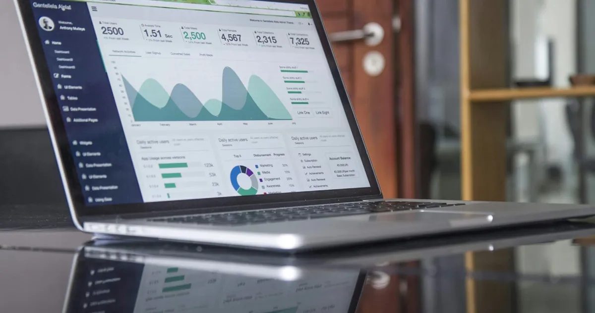 Business charts and graphs on paper and screen