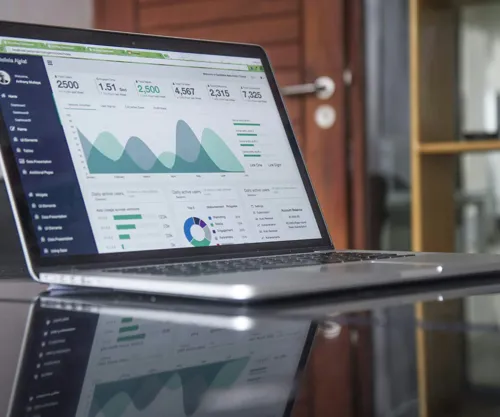 Business charts and graphs on paper and screen